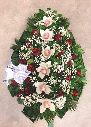 A large funeral wreath with lilies